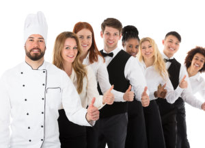 Confident Restaurant Staff Gesturing Thumbs Up