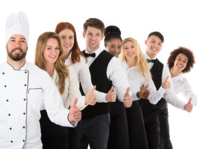 Confident Restaurant Staff Gesturing Thumbs Up